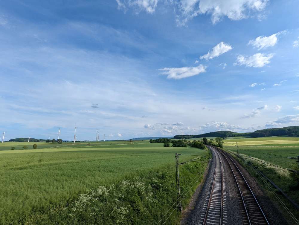 Green fields and a train track in Germany