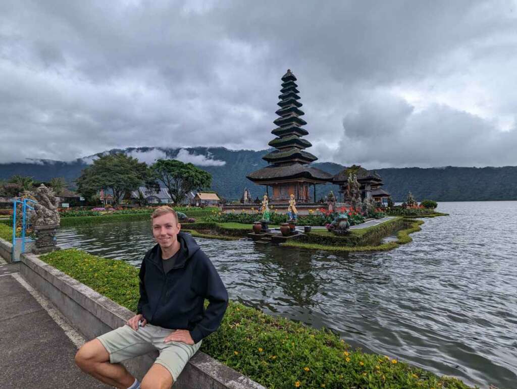 Lukas sitting in front of one of the most reviewed temples in Bali - Ulun Danu Beratan Temple