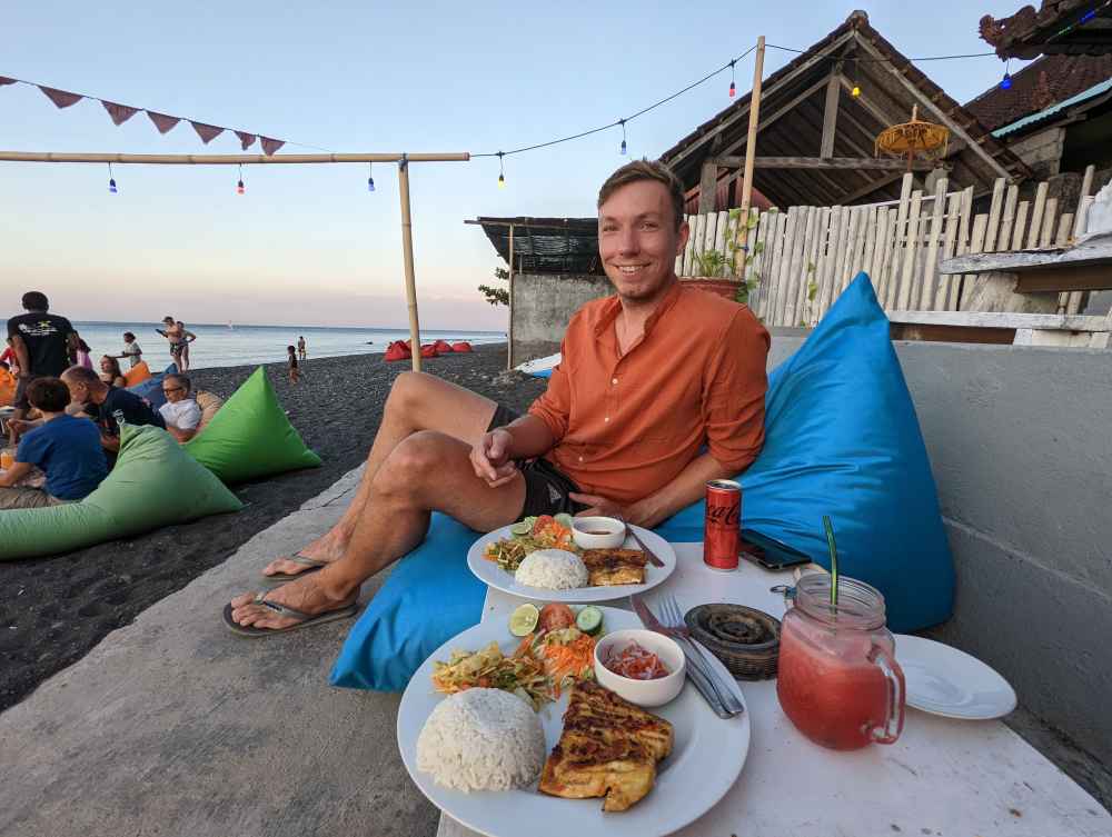 Bean bags and food at the beach at warung Bobo.